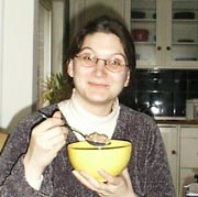 Yellow bowl full of cereal with anonymous owner