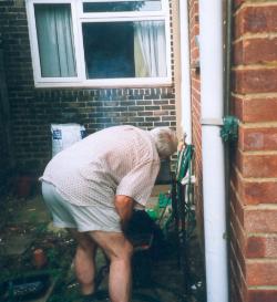 Man hiding behind drainpipe